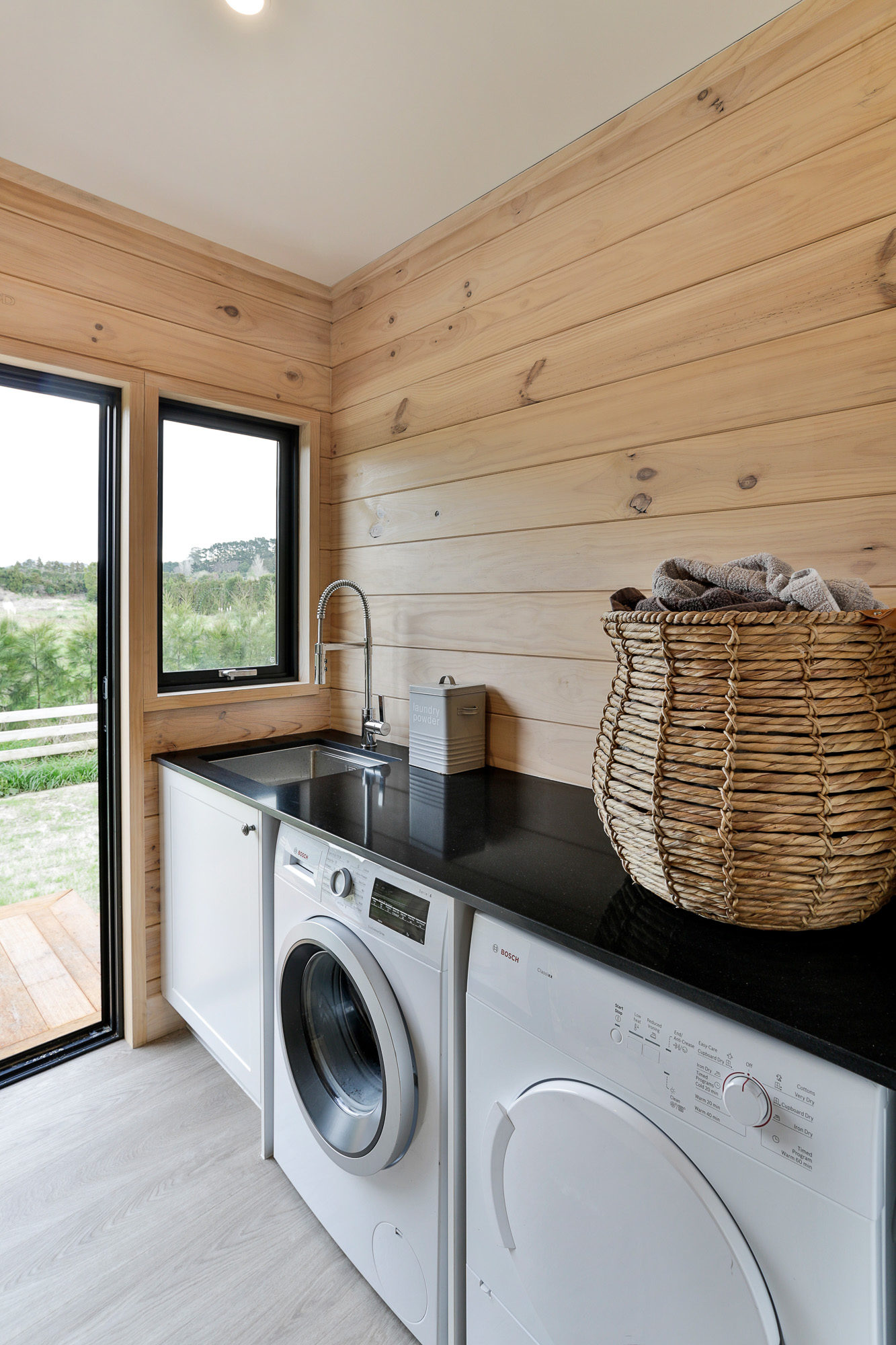Lockwood home laundry with black stone benchtop in Papamoa